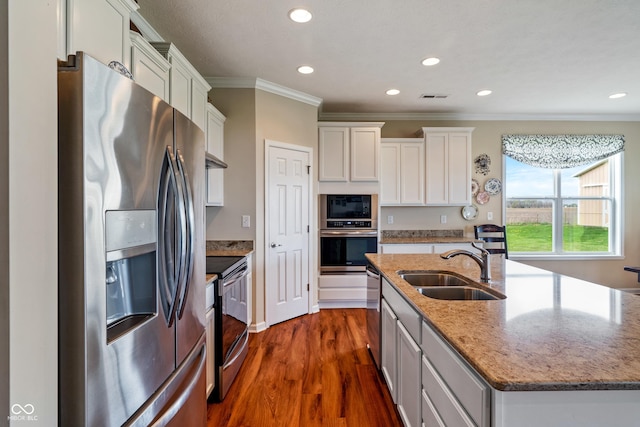 52 E 286th St, Atlanta, IN 46031 - kitchen with a sink, stainless steel appliances, a center island with sink, ornamental molding, and visible vents