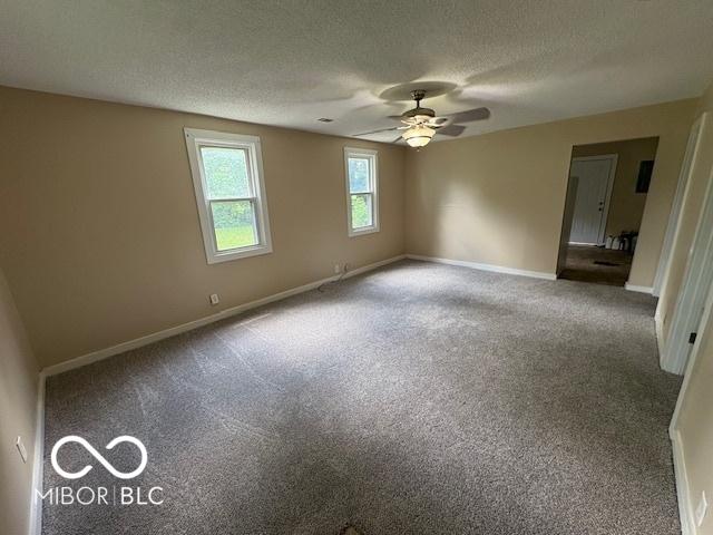 2413 N Macedonia Ave, Muncie, IN 47303 - unfurnished room with a textured ceiling, a ceiling fan, and carpet floors