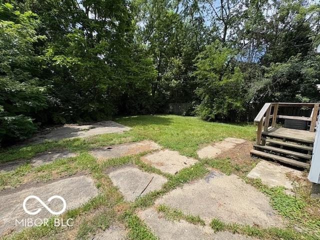 2413 N Macedonia Ave, Muncie, IN 47303 - view of green lawn with a wooden deck