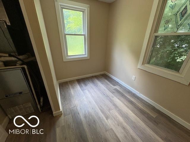 2413 N Macedonia Ave, Muncie, IN 47303 - unfurnished bedroom featuring wood finished floors and baseboards