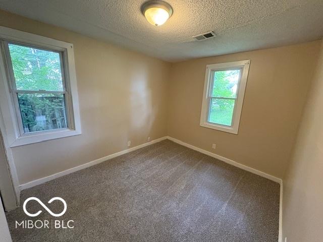 2413 N Macedonia Ave, Muncie, IN 47303 - carpeted spare room featuring a textured ceiling and baseboards