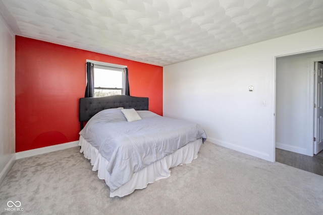carpeted bedroom featuring baseboards