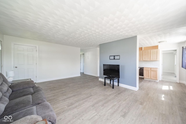 living room with baseboards and light wood-type flooring