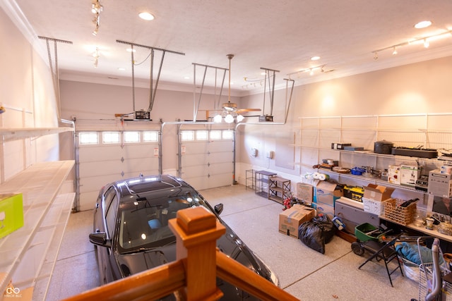 garage with a garage door opener and recessed lighting