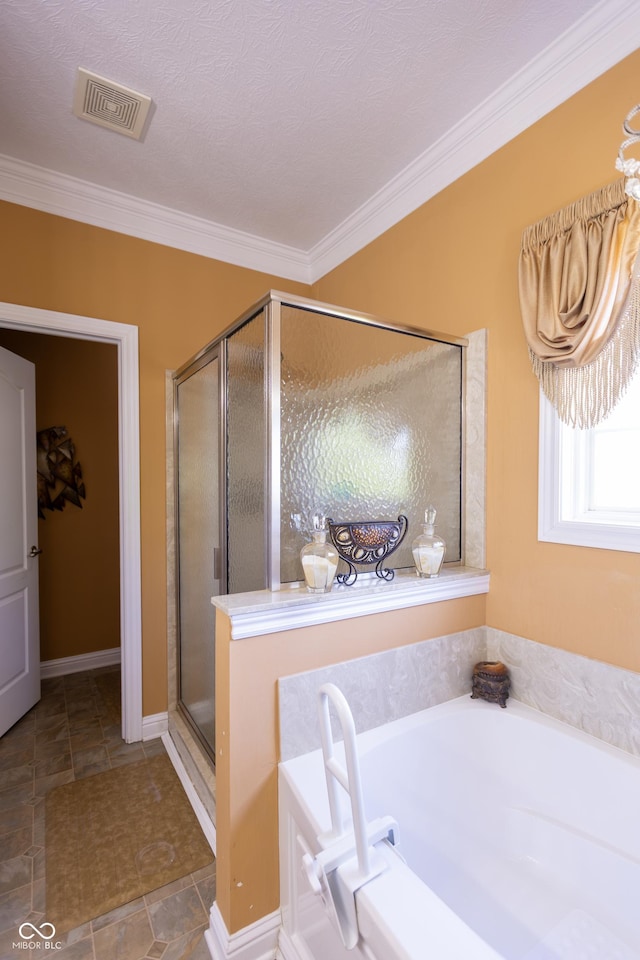bathroom with ornamental molding, a bath, visible vents, and a shower stall