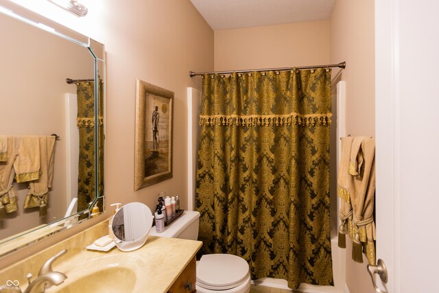 full bathroom with toilet and vanity