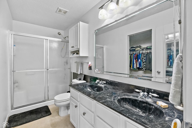 853 Westpointe Dr, Shelbyville, IN 46176 - bathroom featuring toilet, visible vents, a sink, and a stall shower