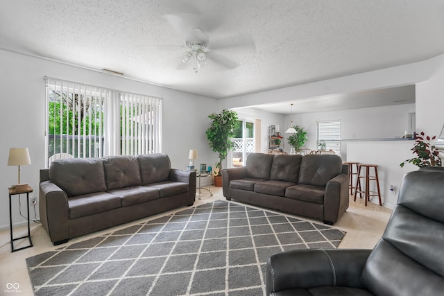 853 Westpointe Dr, Shelbyville, IN 46176 - carpeted living area featuring plenty of natural light, a textured ceiling, ceiling fan, and visible vents