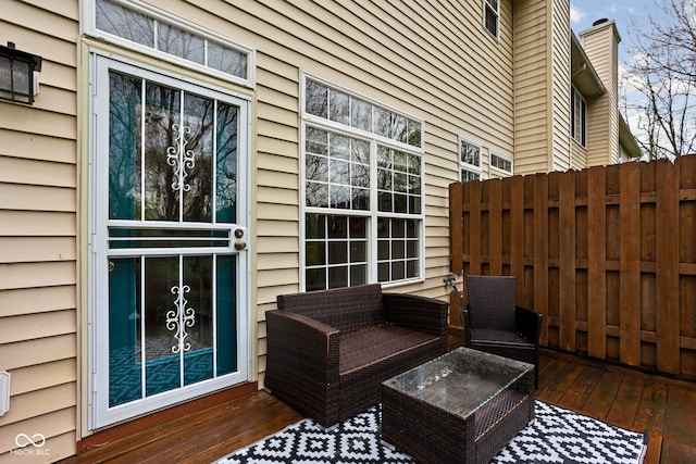 wooden terrace featuring fence and outdoor lounge area
