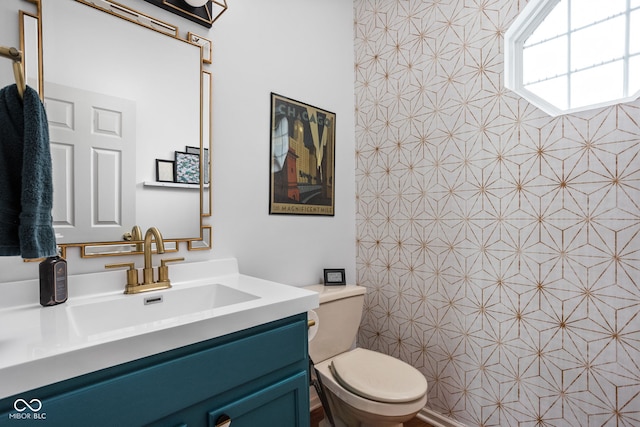 full bathroom with toilet and vanity
