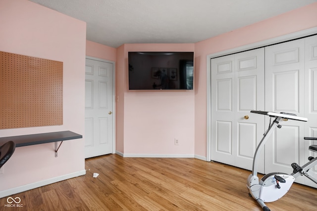 interior space with baseboards and light wood-style flooring