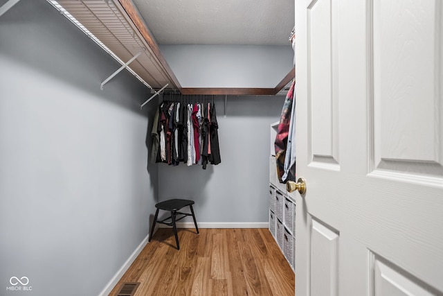 spacious closet with visible vents and wood finished floors