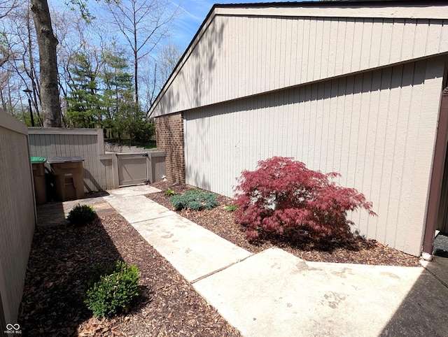 view of side of property with a patio, a gate, and fence