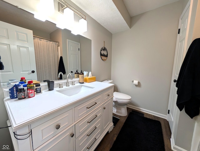 bathroom with vanity, baseboards, toilet, and a shower with shower curtain