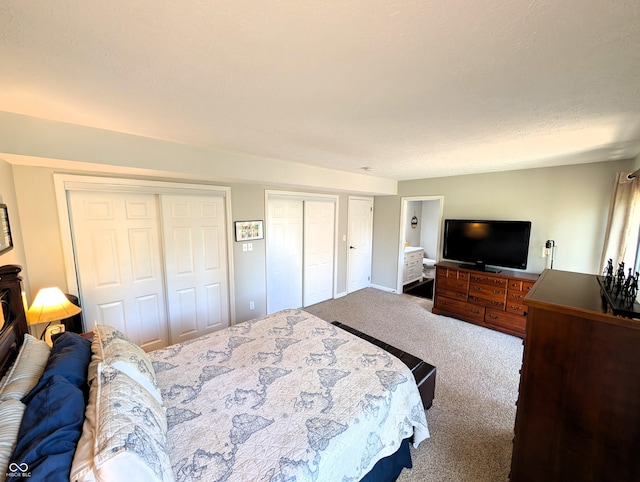 carpeted bedroom featuring two closets