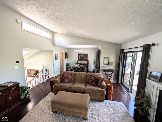 living room with vaulted ceiling, dark wood-style flooring, a textured ceiling, and a notable chandelier