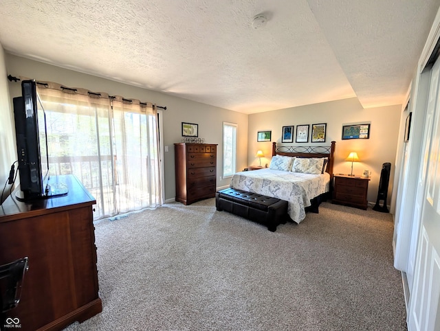 bedroom featuring a textured ceiling, baseboards, and carpet