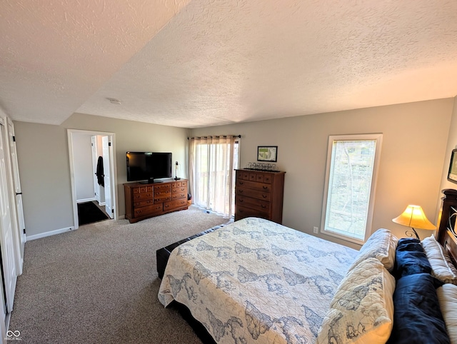 bedroom featuring baseboards, carpet flooring, and a textured ceiling