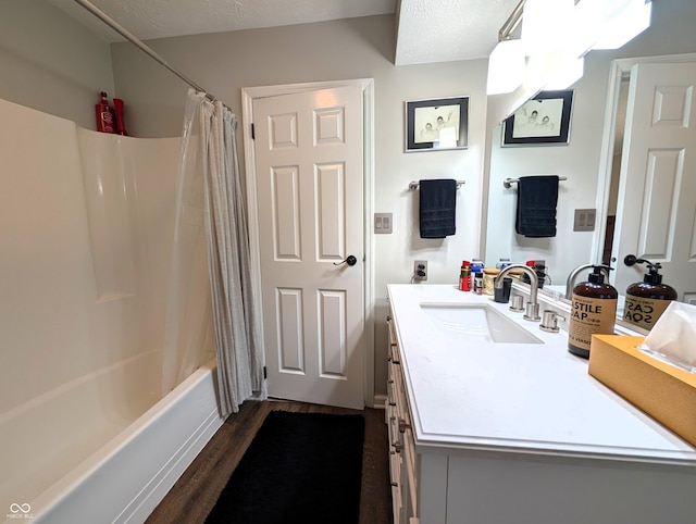 bathroom with shower / bath combo with shower curtain, wood finished floors, and vanity