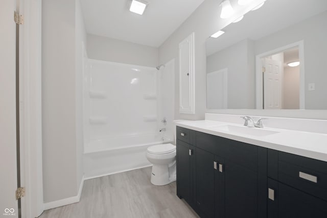 bathroom featuring wood finished floors, vanity, bathtub / shower combination, baseboards, and toilet