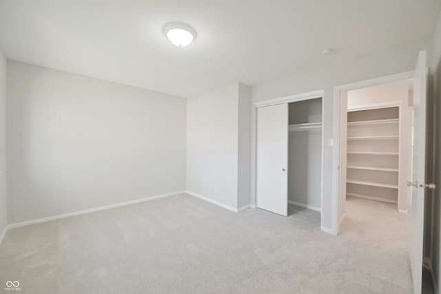 unfurnished bedroom featuring baseboards, carpet flooring, and a closet