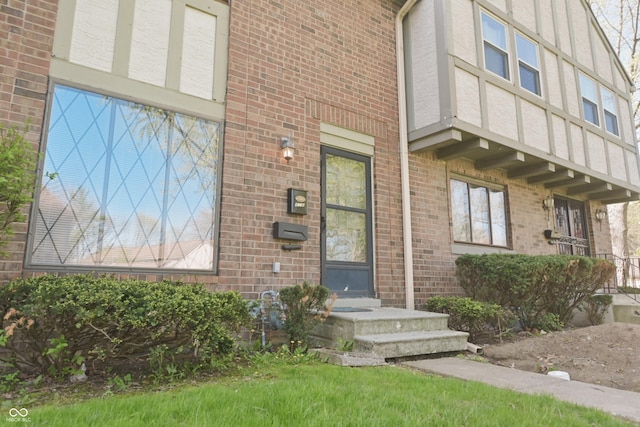 doorway to property with brick siding
