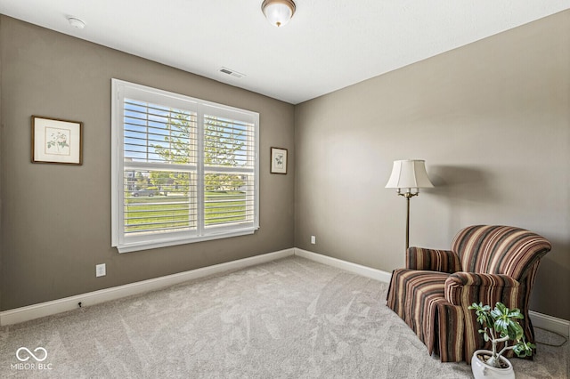sitting room with visible vents, baseboards, and carpet floors