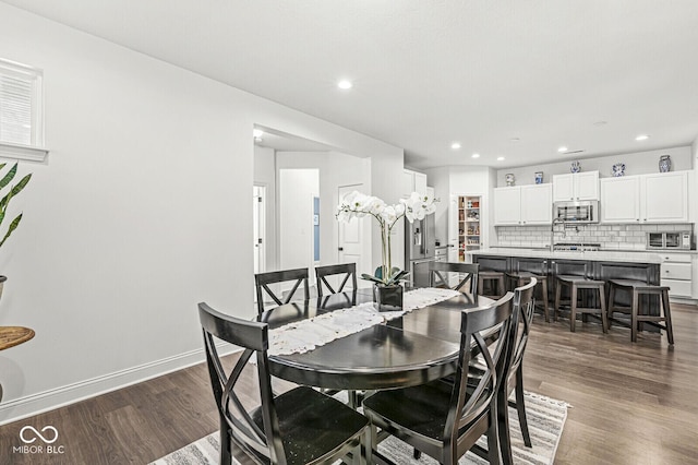 dining area with recessed lighting, dark wood-style flooring, and baseboards