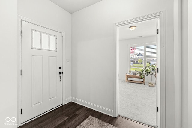 entryway with baseboards and dark wood-style flooring