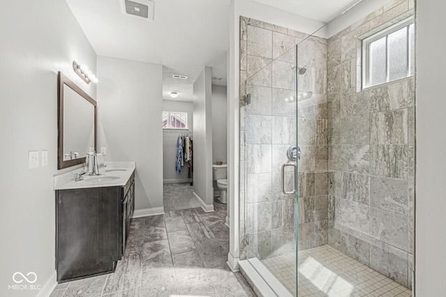bathroom with visible vents, plenty of natural light, a stall shower, and vanity