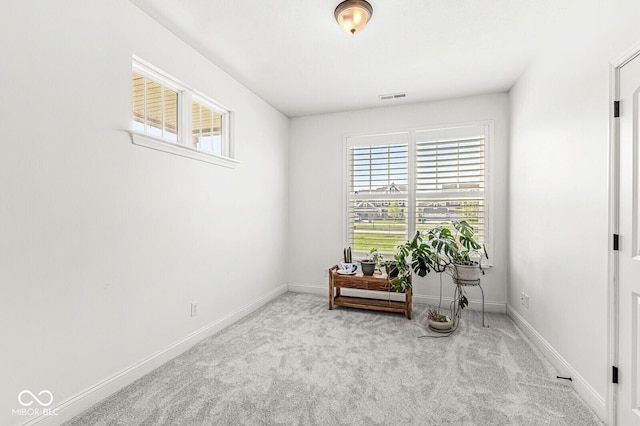 sitting room with visible vents, carpet flooring, baseboards, and plenty of natural light