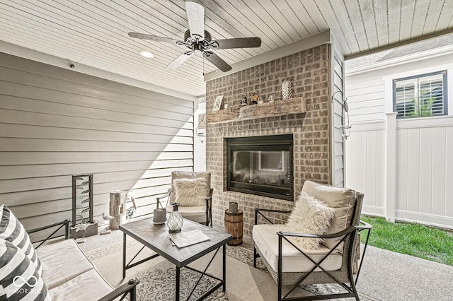 view of patio with a ceiling fan and a fireplace