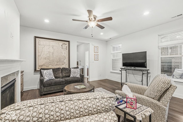 living room featuring ceiling fan, visible vents, and dark wood-type flooring