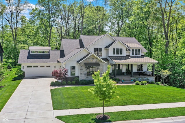 10725 Holliday Farms Blvd, Zionsville, IN 46077 - modern farmhouse style home featuring board and batten siding, concrete driveway, covered porch, stone siding, and a front lawn