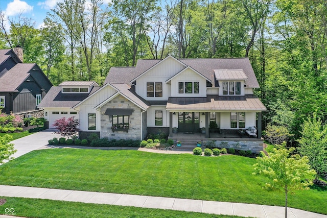 10725 Holliday Farms Blvd, Zionsville, IN 46077 - modern farmhouse style home featuring board and batten siding, a porch, concrete driveway, a standing seam roof, and a front yard