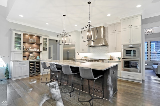 10725 Holliday Farms Blvd, Zionsville, IN 46077 - kitchen with beverage cooler, stainless steel appliances, wall chimney exhaust hood, a sink, and crown molding