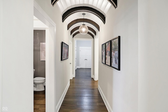 10725 Holliday Farms Blvd, Zionsville, IN 46077 - hallway with dark wood finished floors, baseboards, arched walkways, and beam ceiling