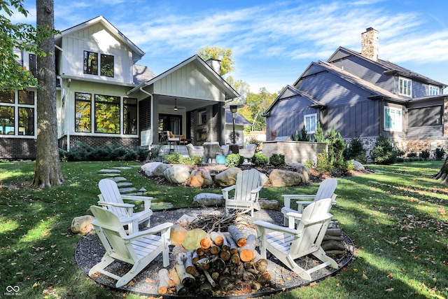 10725 Holliday Farms Blvd, Zionsville, IN 46077 - back of house with an outdoor fire pit, a patio, board and batten siding, a yard, and a chimney