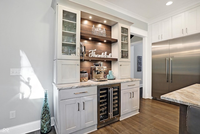 10725 Holliday Farms Blvd, Zionsville, IN 46077 - indoor dry bar with wine cooler, stainless steel built in refrigerator, dark wood-type flooring, baseboards, and recessed lighting
