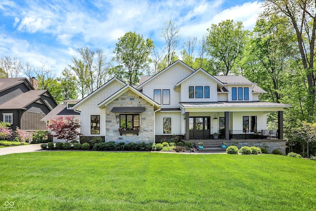 10725 Holliday Farms Blvd, Zionsville, IN 46077 - modern farmhouse with board and batten siding, covered porch, a front yard, a standing seam roof, and stone siding