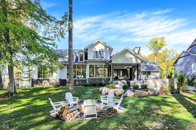 10725 Holliday Farms Blvd, Zionsville, IN 46077 - back of house with an outdoor fire pit, a ceiling fan, a patio area, a lawn, and a chimney
