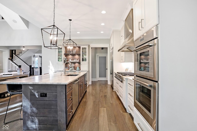 10725 Holliday Farms Blvd, Zionsville, IN 46077 - kitchen featuring white cabinetry, a sink, a large island with sink, a breakfast bar, and glass insert cabinets