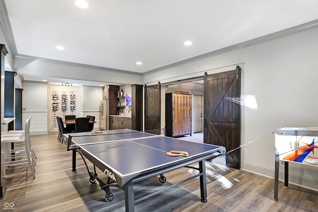 10725 Holliday Farms Blvd, Zionsville, IN 46077 - recreation room with wood finished floors, recessed lighting, a barn door, and baseboards