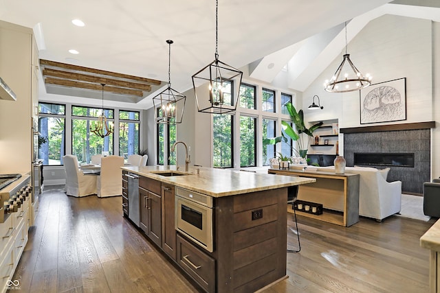 10725 Holliday Farms Blvd, Zionsville, IN 46077 - kitchen with a chandelier, a sink, dark brown cabinetry, dark wood-style floors, and recessed lighting