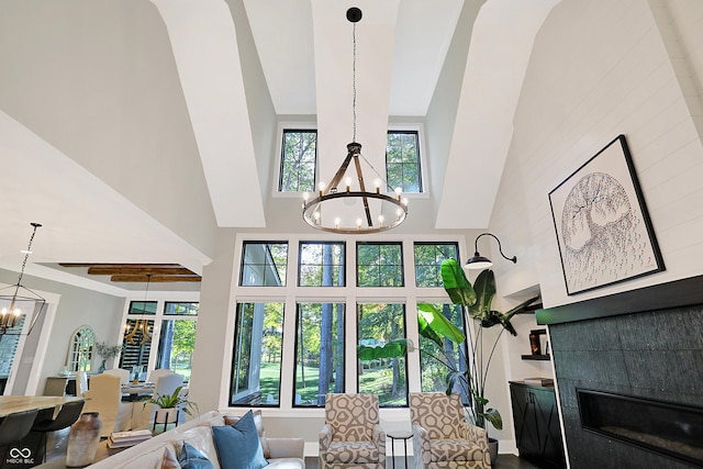 10725 Holliday Farms Blvd, Zionsville, IN 46077 - living room featuring a chandelier, a high ceiling, a tile fireplace, and baseboards
