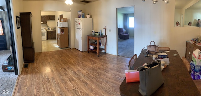 interior space featuring an inviting chandelier, light wood finished floors, and visible vents