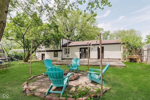 8041 Barry Rd, Indianapolis, IN 46219 - rear view of house featuring a fire pit, french doors, and a trampoline