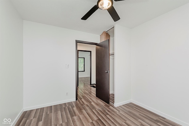 8041 Barry Rd, Indianapolis, IN 46219 - empty room with ceiling fan, light wood finished floors, and baseboards