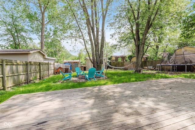 8041 Barry Rd, Indianapolis, IN 46219 - wooden deck with a trampoline, a shed, and an outdoor structure