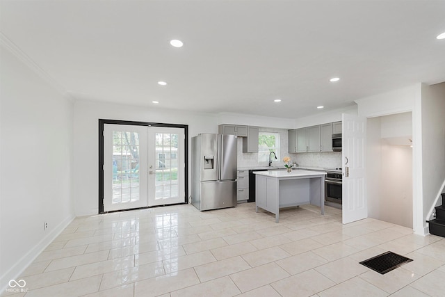8041 Barry Rd, Indianapolis, IN 46219 - kitchen with appliances with stainless steel finishes, gray cabinets, light countertops, a sink, and crown molding